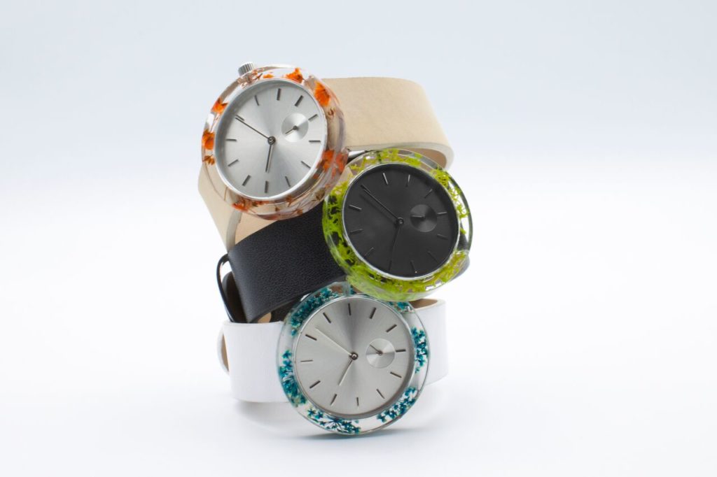 The Botanist Watch by Analog with natural moss, flowers in the resin case. $109.
